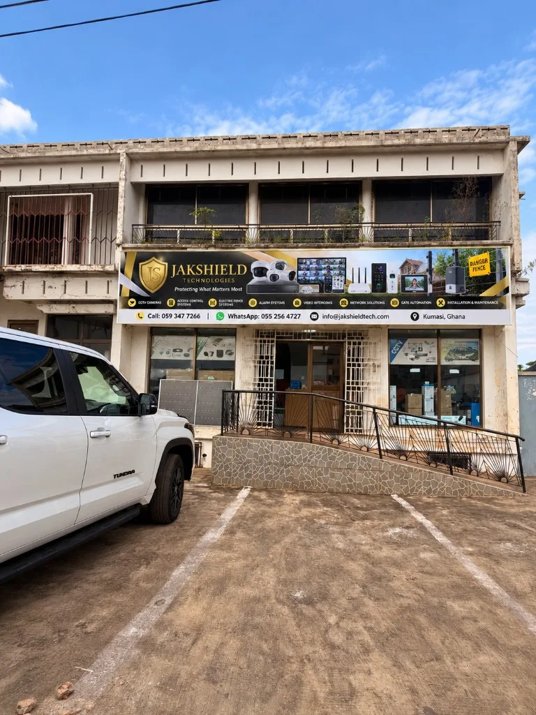 The JakShield Technologies shop in Bantama, Kumasi, with the black-and-gold JakShield signboard.