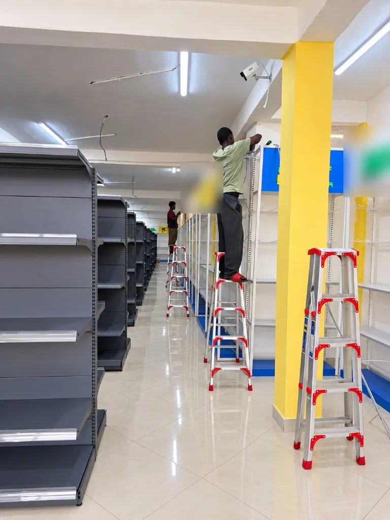 JakShield technicians fitting cameras above the shelving of a new retail store