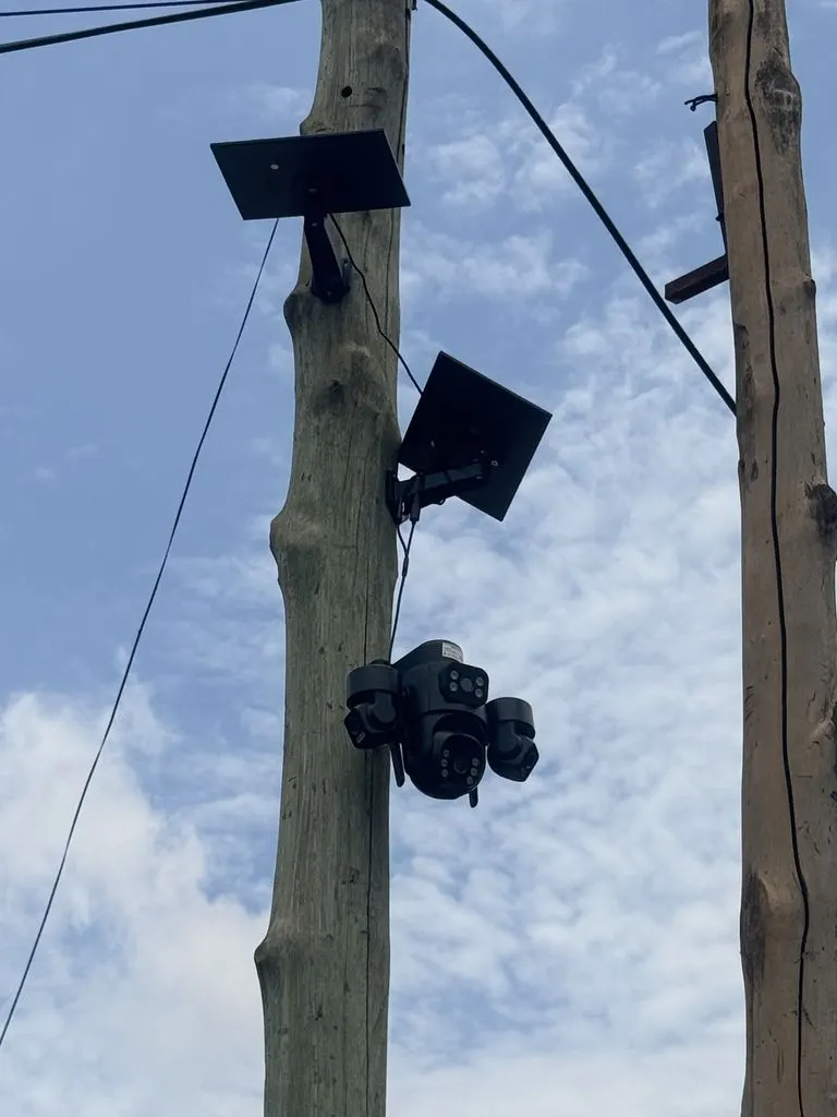 Solar-powered camera mounted on a pole at a site without mains power